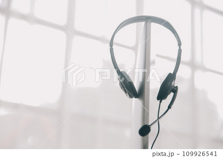 Communication support, call center and customer service help desk. VOIP headset on telephone keyboard. Communication support, call center and customer service help desk. VOIP headset on telephone keyboard. 109926541