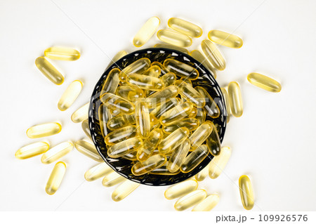 Omega 3 capsules on a black plate. Fish oil capsules. Dietary supplement Omega 3 capsules on a black plate. Fish oil capsules. Dietary supplement 109926576
