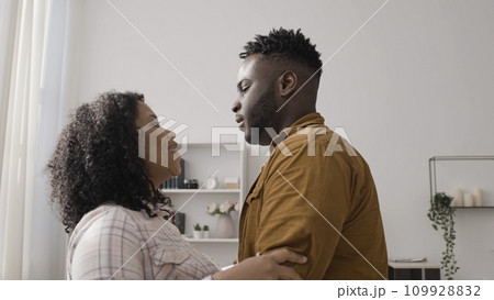 Happy African American couple hugs as the woman tells her husband that she is pregnant Happy African American couple hugs as the woman tells her husband that she is pregnant 109928832