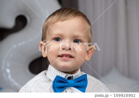 Portrait of an elegant little boy in a shirt with a bow tie 109928902
