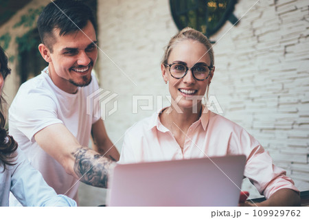 Group of smiling coworkers using notebook and gadgets 109929762