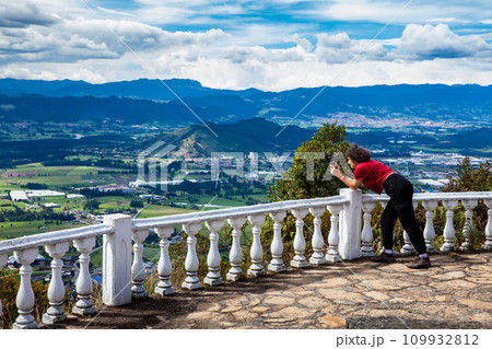 Young woman at a viewpoint over the beautiful Sopo valley at the department of Cundinamarca in Colombia 109932812