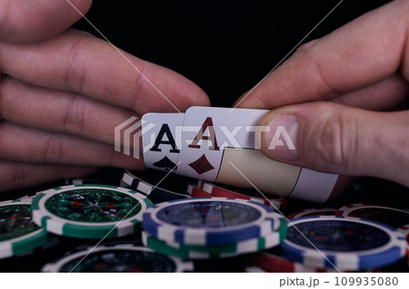 Dealer or croupier shuffles poker cards in a casino on the background of a table, chips. Concept of poker game. Playing for money, a big win, jackpot. 109935080