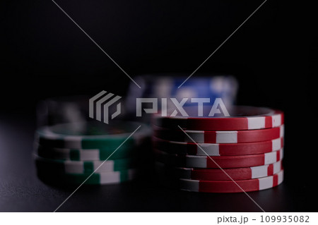Dealer or croupier shuffles poker cards in a casino on the background of a table, chips. Concept of poker game. Playing for money, a big win, jackpot. Dealer or croupier shuffles poker cards in a casino on the background of a table, chips. Concept of poker game. Playing for money, a big win, jackpot. 109935082