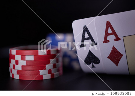 Dealer or croupier shuffles poker cards in a casino on the background of a table, chips. Concept of poker game. Playing for money, a big win, jackpot. 109935085