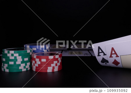 Dealer or croupier shuffles poker cards in a casino on the background of a table, chips. Concept of poker game. Playing for money, a big win, jackpot. Dealer or croupier shuffles poker cards in a casino on the background of a table, chips. Concept of poker game. Playing for money, a big win, jackpot. 109935092