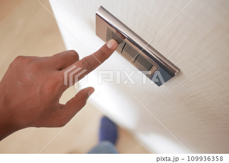 A finger turning on lighting switch . A finger turning on lighting switch . 109936358