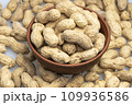 peanuts in a shell in a clay plate, organic peanuts isolated on a white background top view. A bunch of peanuts in close-up, selective focus. 109936586