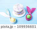 Easter cake and colorful Easter eggs close-up top view, selective focus, tinted image 109936601