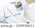 white helmet and tape measure, pencil ruler and construction drawings, selective focus, tinted image, construction concept repair and reconstruction of buildings and structures 109936611