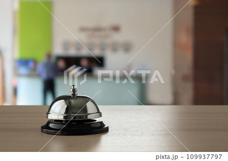 Hotel service bell on wood counter background 109937797