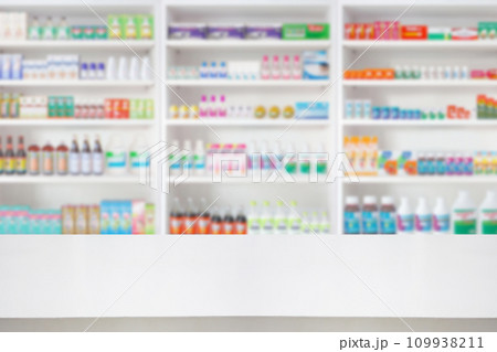 Empty wood counter top with pharmacy drugstore shelves blur pharmaceutical medicine product background Empty wood counter top with pharmacy drugstore shelves blur pharmaceutical medicine product background 109938211