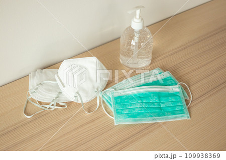 Medical face mask with alcohol sanitizer gel hand wash on wood table for covid-19 Coronavirus prevention concept 109938369
