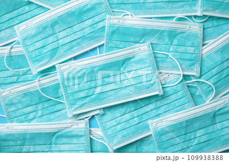 Blue surgical face mask texture background protection against air pollution and COVID-19 coronavirus. Healthcare and medical concept Blue surgical face mask texture background protection against air pollution and COVID-19 coronavirus. Healthcare and medical concept 109938388