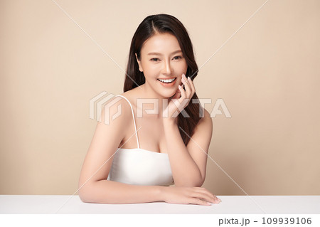 Beautiful young asian woman with clean fresh skin on beige background, Face care, Facial treatment, Cosmetology, beauty and spa, Asian women portrait. Beautiful young asian woman with clean fresh skin on beige background, Face care, Facial treatment, Cosmetology, beauty and spa, Asian women portrait. 109939106
