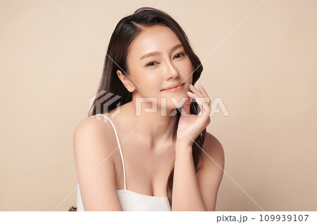 Beautiful young asian woman with clean fresh skin on beige background, Face care, Facial treatment, Cosmetology, beauty and spa, Asian women portrait. Beautiful young asian woman with clean fresh skin on beige background, Face care, Facial treatment, Cosmetology, beauty and spa, Asian women portrait. 109939107