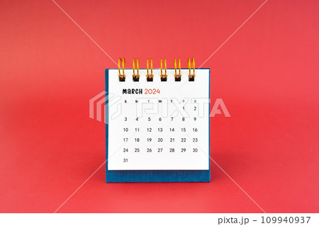 March 2024 white desk calendar on red background. March 2024 white desk calendar on red background. 109940937