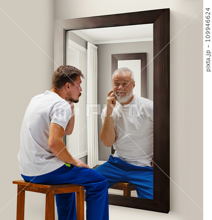 Inner talk. Man in his 30s looking in mirror with elderly reflection of him. Senior and young man. Conceptual collage. Age, past and present, generation Inner talk. Man in his 30s looking in mirror with elderly reflection of him. Senior and young man. Conceptual collage. Age, past and present, generation 109946624