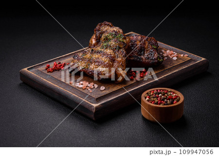 Delicious juicy beef or chicken steak with salt, spices and herbs Delicious juicy beef or chicken steak with salt, spices and herbs 109947056