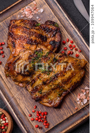 Delicious juicy beef or chicken steak with salt, spices and herbs Delicious juicy beef or chicken steak with salt, spices and herbs 109947064