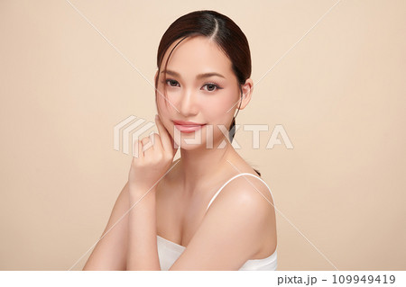 Beautiful young asian woman with clean fresh skin on beige background, Face care, Facial treatment, Cosmetology, beauty and spa, Asian women portrait. 109949419
