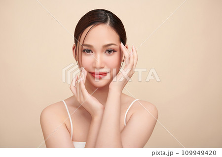 Beautiful young asian woman with clean fresh skin on beige background, Face care, Facial treatment, Cosmetology, beauty and spa, Asian women portrait. 109949420