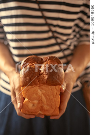 Female hands holding homemade fresh bread Female hands holding homemade fresh bread 109949960