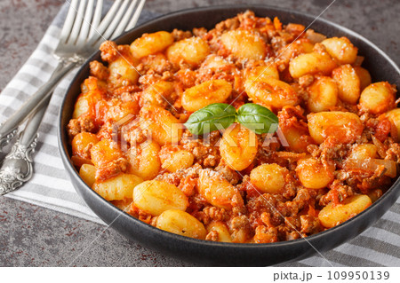 Hot Potato gnocchi with traditional Bolognese sauce and Parmesan cheese closeup on the plate. Horizontal Hot Potato gnocchi with traditional Bolognese sauce and Parmesan cheese closeup on the plate. Horizontal 109950139
