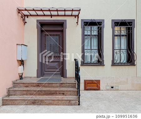 Bright doorway, decorated windows, and inviting stairs lead to a cozy home in Istanbul's Kuzguncuk neighborhood, Turkey Bright doorway, decorated windows, and inviting stairs lead to a cozy home in Istanbul's Kuzguncuk neighborhood, Turkey 109951636