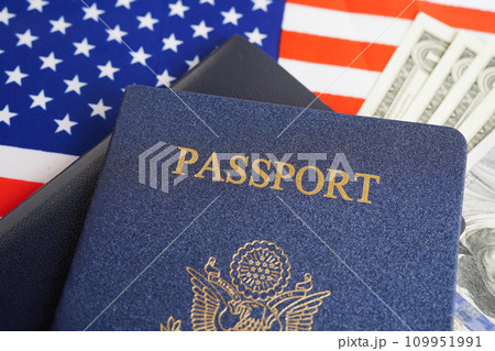 US passport with dollar money on USA flag, American citizen in United States of America. 109951991