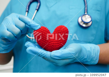 Asian woman doctor holding red heart for health in hospital. Asian woman doctor holding red heart for health in hospital. 109952047