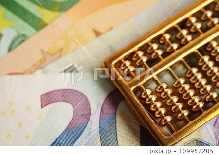 Gold abacus on banknote money, finance trading investment business currency concept. Gold abacus on banknote money, finance trading investment business currency concept. 109952205