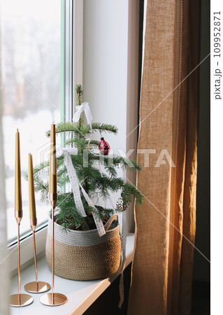 candles and decorations for the Christmas tree in eco style. Zero Waste Christmas concept. Vintage Christmas tree decorations. Holiday Template with Christmas decorations on fir tree  109952871