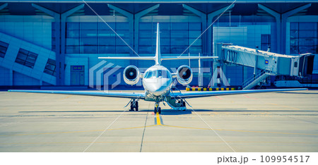 Silver shiny airplane at runway 109954517