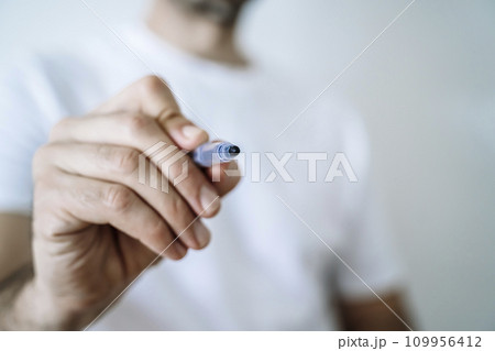 Hand with pen marker or pencil. Signature, drawing school concept background. Hand with pen marker or pencil. Signature, drawing school concept background. 109956412