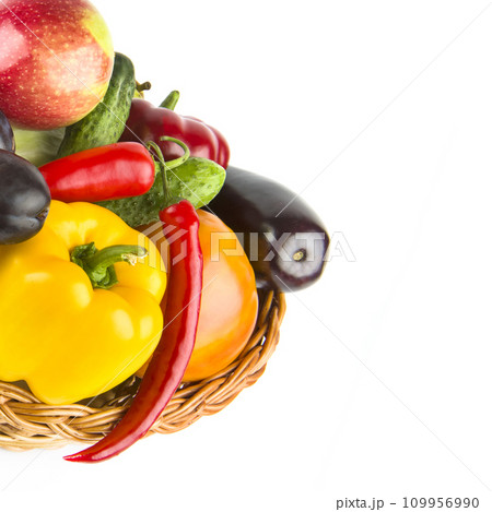 Fruits and vegetables in a wicker basket isolated on a white. Free space for text. 109956990