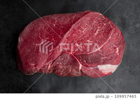 Raw beef steak on a dark slate background. Top view Raw beef steak on a dark slate background. Top view 109957465