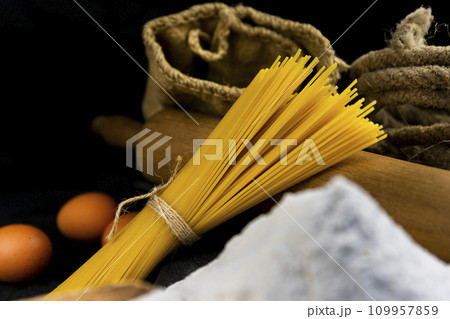 Fresh uncooked Spaghetti and pasta ingredients on a rustic table 109957859