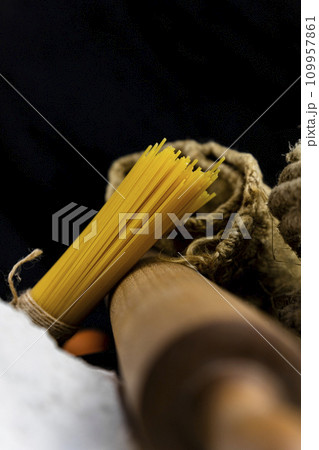 Fresh uncooked Spaghetti and pasta ingredients on a rustic table 109957861