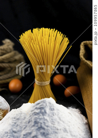 Fresh uncooked Spaghetti and pasta ingredients on a rustic table 109957865