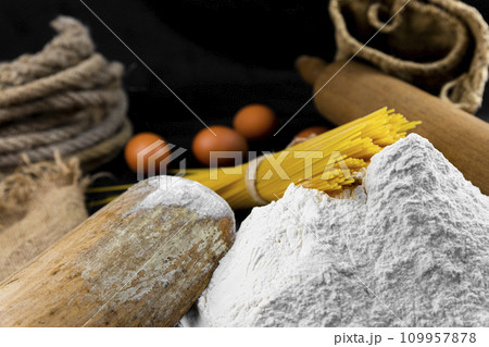 Fresh uncooked Spaghetti and pasta ingredients on a rustic table Fresh uncooked Spaghetti and pasta ingredients on a rustic table 109957878