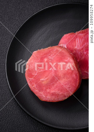 Round shape steaks of raw juicy tuna with salt and spices Round shape steaks of raw juicy tuna with salt and spices 109958274