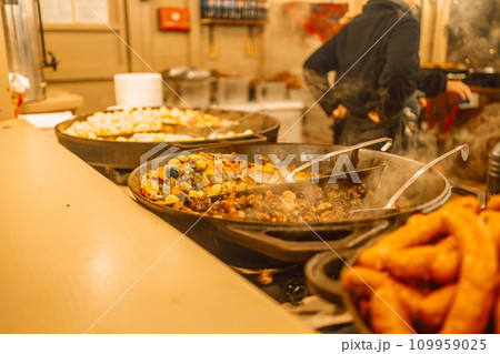 Festival of street food at a Christmas Market stall in Krakow, Poland. Traditional Polish street food. Festival of street food at a Christmas Market stall in Krakow, Poland. Traditional Polish street food. 109959025