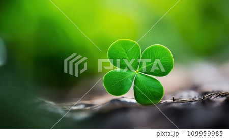 AI-generated content. A four leaf clover is sitting on the ground in front of a forest, AI 109959985