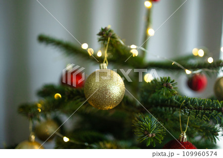 Close up of decorated Christmas tree with glitter effects on blurred background. New Year concept. Close up of decorated Christmas tree with glitter effects on blurred background. New Year concept. 109960574