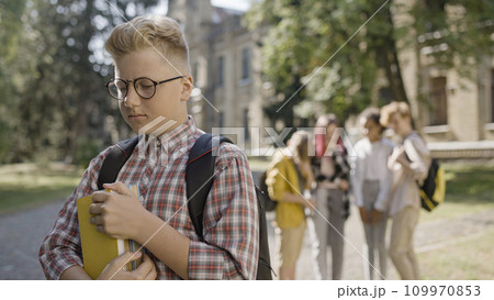 Overweight school boy in eyeglasses suffering from bullying by classmates, abuse Overweight school boy in eyeglasses suffering from bullying by classmates, abuse 109970853