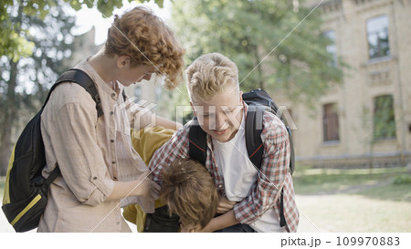 Two school kids bullying unpopular classmate, physical abuse problem in schools Two school kids bullying unpopular classmate, physical abuse problem in schools 109970883