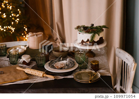 Christmas table set with cake and decor Christmas table set with cake and decor 109971054