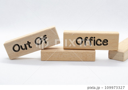 Out of office text on wooden blocks with white background. Out of office concept. Out of office text on wooden blocks with white background. Out of office concept. 109973327