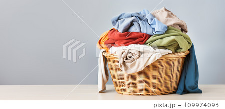 Wicker basket with dirty laundry close-up, banner format Wicker basket with dirty laundry close-up, banner format 109974093